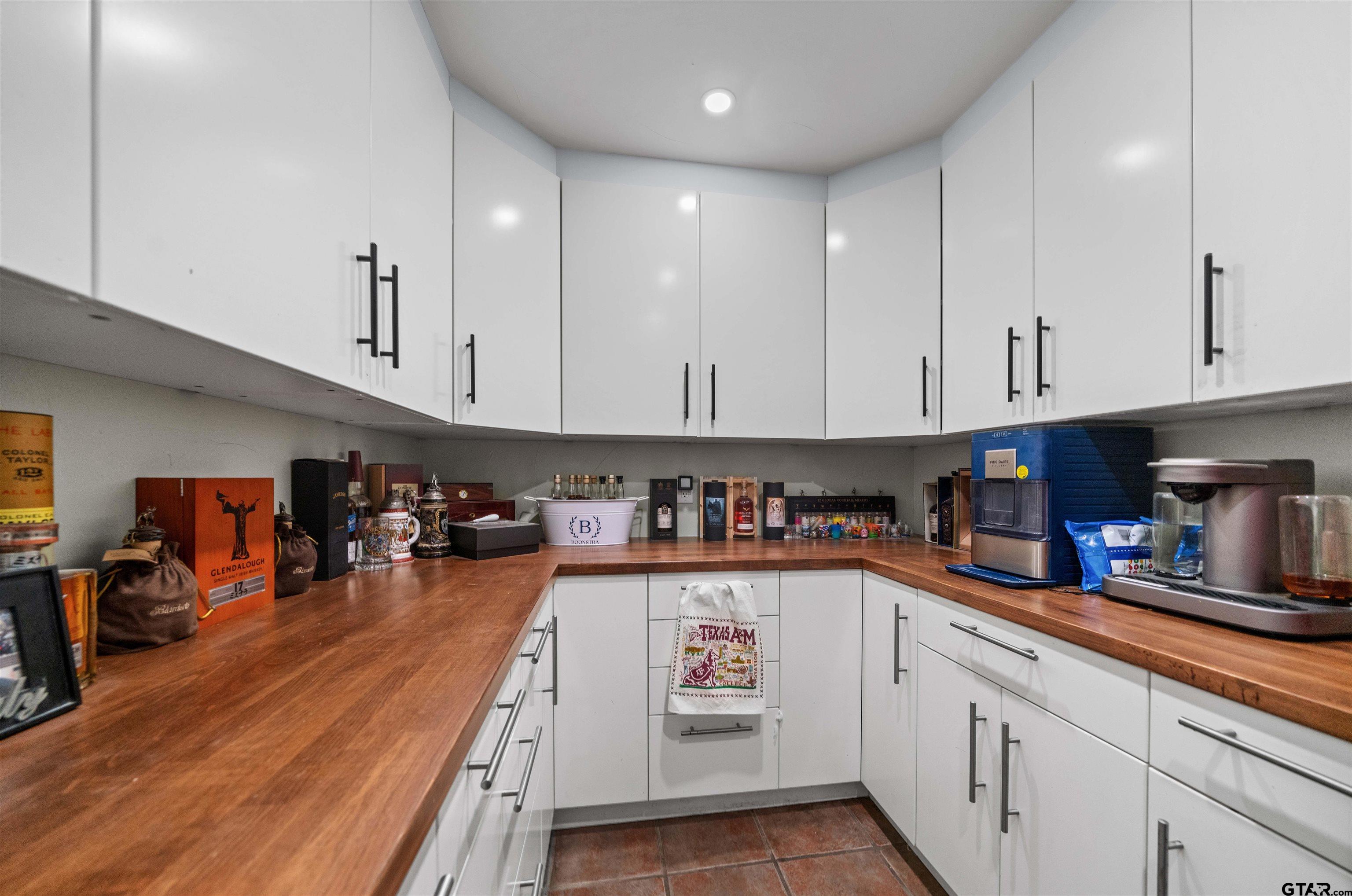 4107 Chester Drive Tyler, TX 75701 - Photo 14 of 45 a kitchen with stainless steel appliances granite countertop a refrigerator a sink dishwasher and white cabinets next to a window