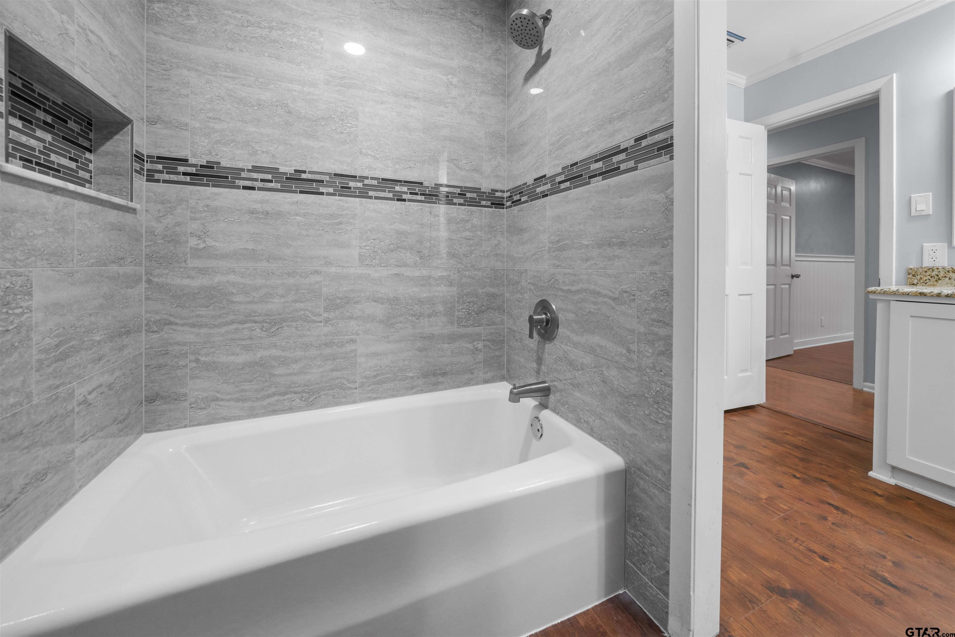 4107 Chester Drive Tyler, TX 75701 - Photo 21 of 45 a bathroom with a bathtub and a shower