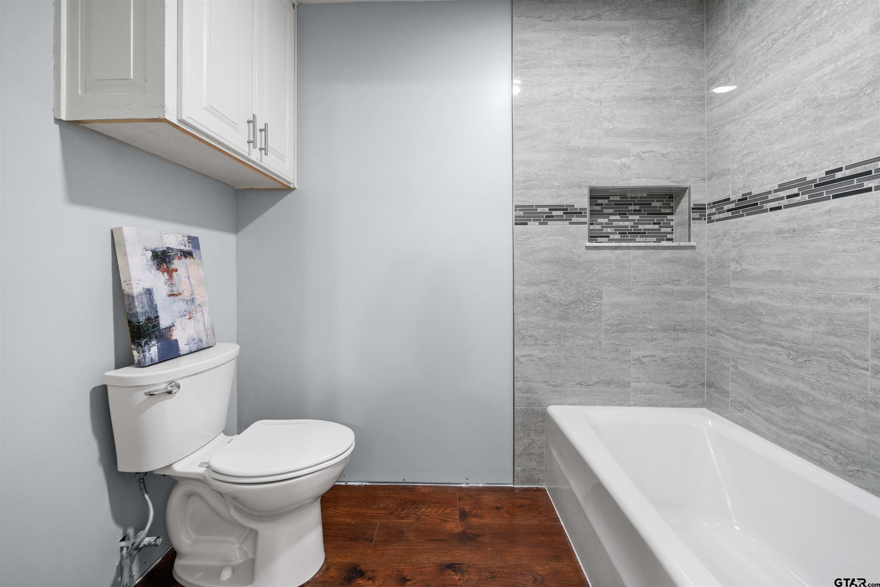4107 Chester Drive Tyler, TX 75701 - Photo 25 of 45 a bathroom with a toilet and a bathtub