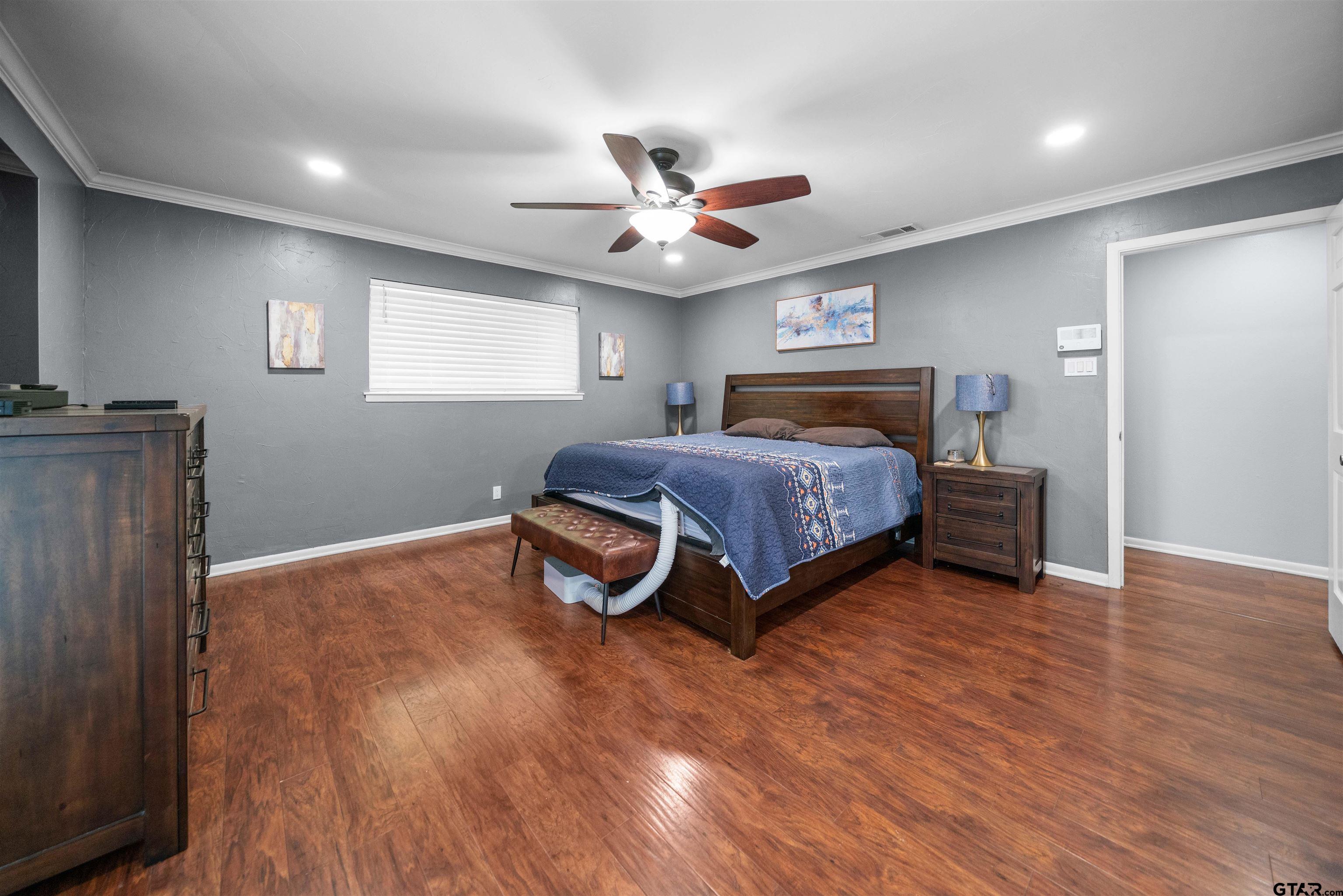 4107 Chester Drive Tyler, TX 75701 - Photo 29 of 45 a bedroom with a bed and a ceiling fan