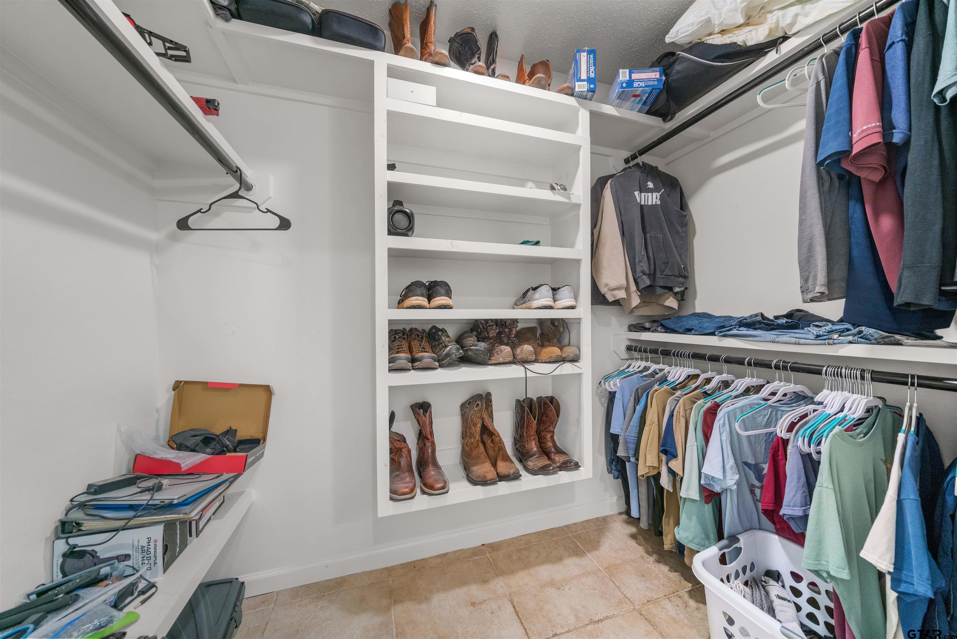 4107 Chester Drive Tyler, TX 75701 - Photo 30 of 45 a view of walk in closet with clothes and shoes