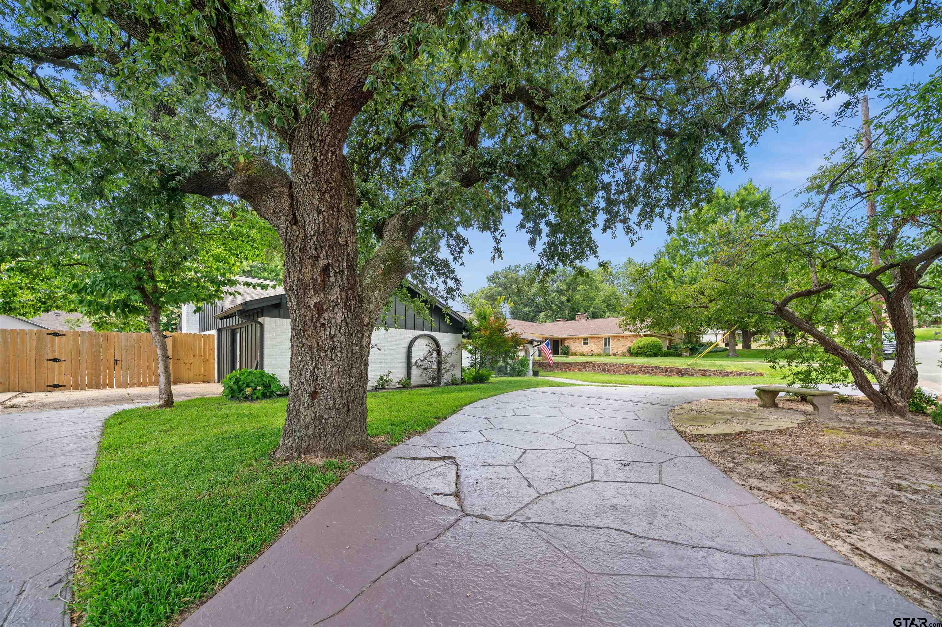 4107 Chester Drive Tyler, TX 75701 - Photo 31 of 45 a view of backyard with large trees and a small yard