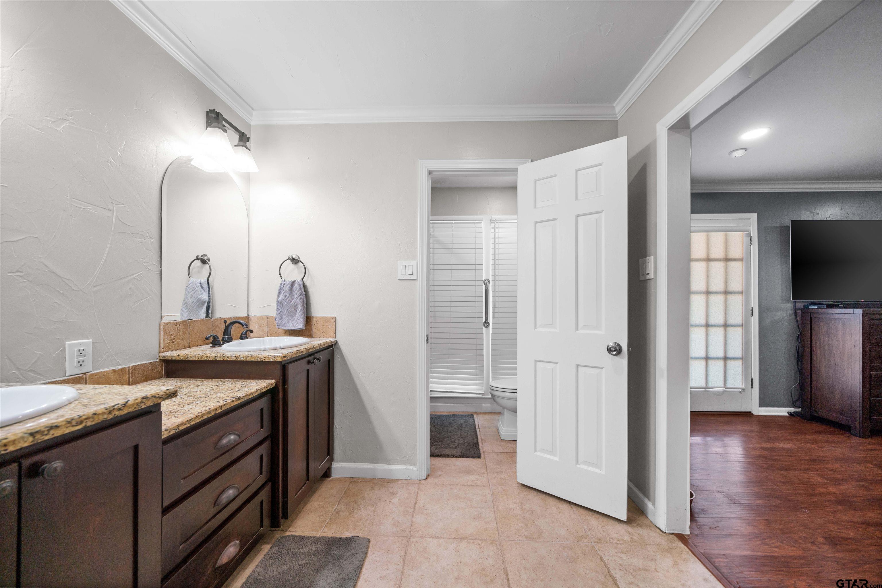 4107 Chester Drive Tyler, TX 75701 - Photo 32 of 45 a spacious bathroom with a double vanity sink and a mirror