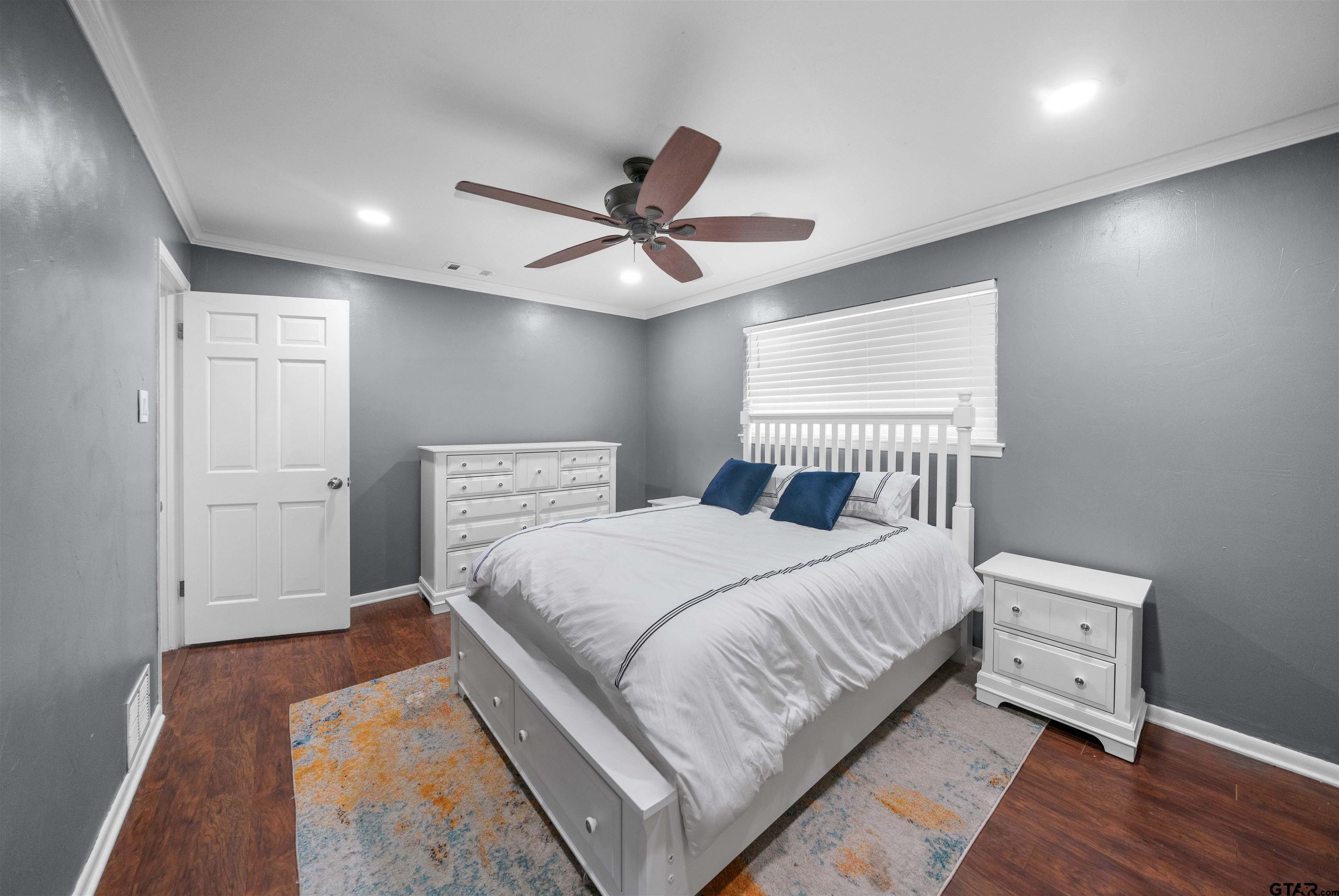 4107 Chester Drive Tyler, TX 75701 - Photo 35 of 45 a bedroom with a bed and a ceiling fan