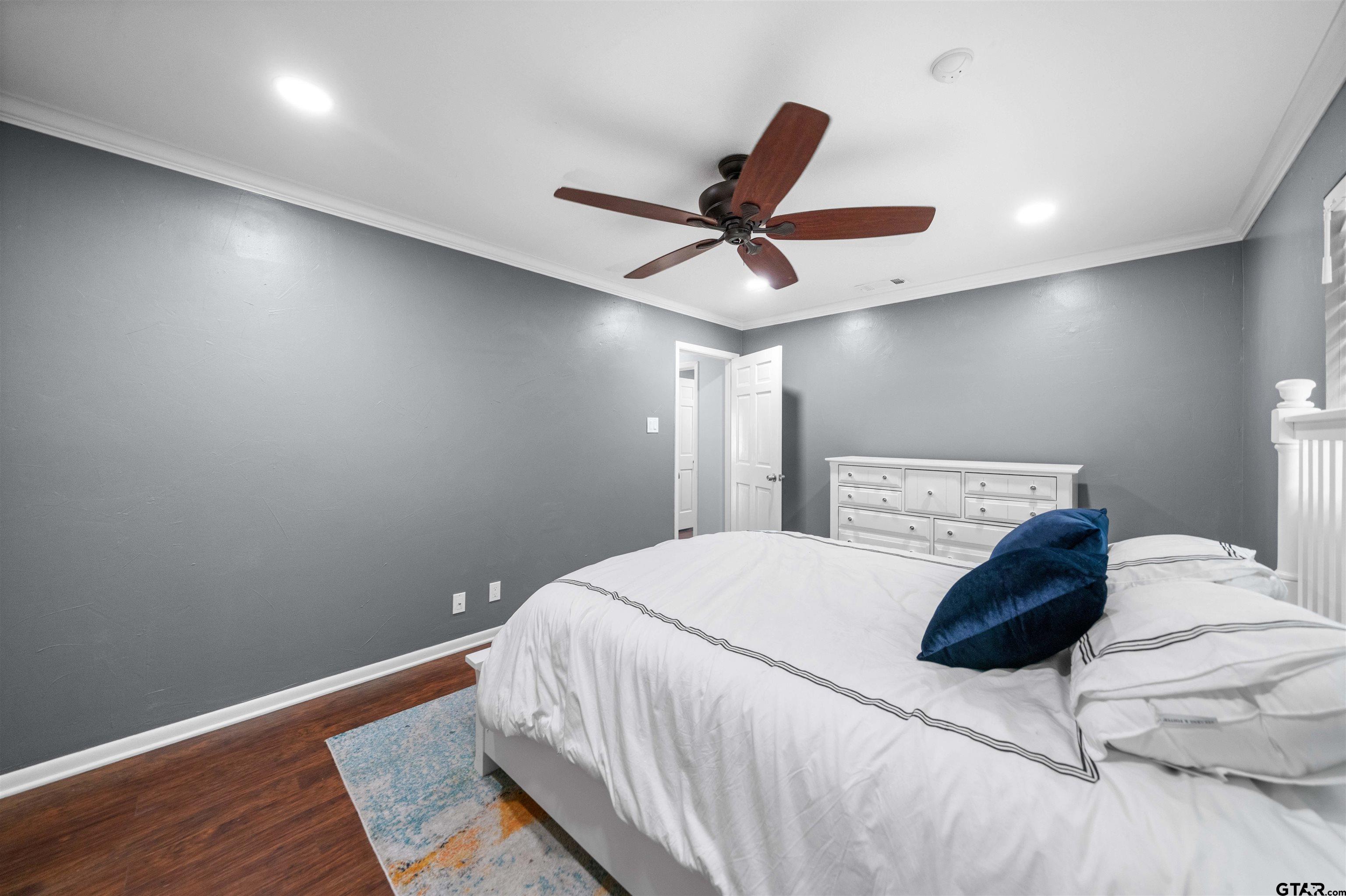 4107 Chester Drive Tyler, TX 75701 - Photo 9 of 45 a bedroom with a bed and a ceiling fan