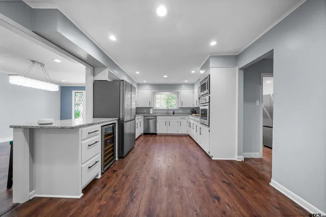 a bathroom with a granite countertop sink and mirror
