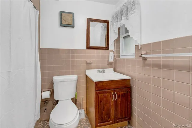 a white toilet sitting next to a bathroom sink