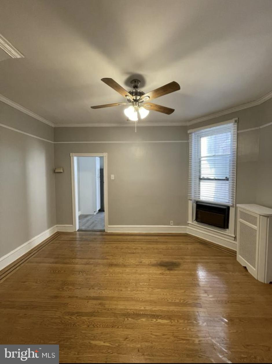 5616 Christian Street Philadelphia, PA 19143 - Photo 5 of 12 a view of an empty room with window and kitchen view