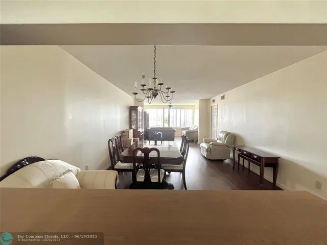 a living room with fireplace furniture and a chandelier