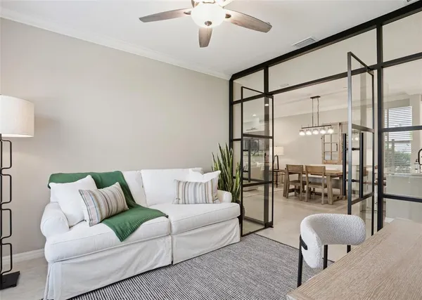 a living room with furniture and a chandelier