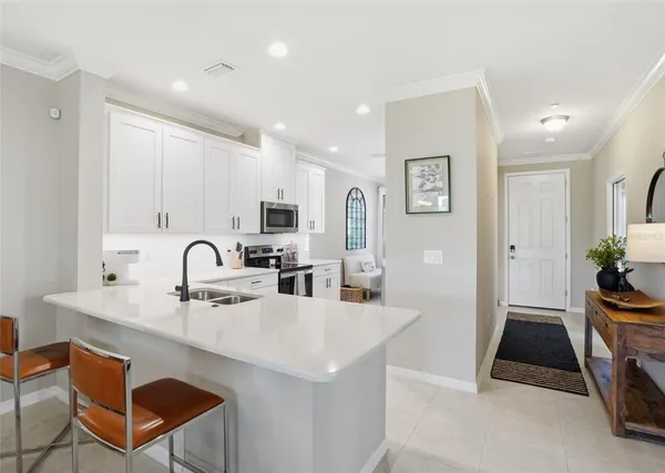 a kitchen with stainless steel appliances a sink stove and cabinets