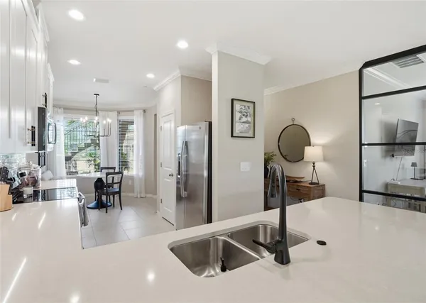 a kitchen with stainless steel appliances kitchen island a refrigerator and a sink