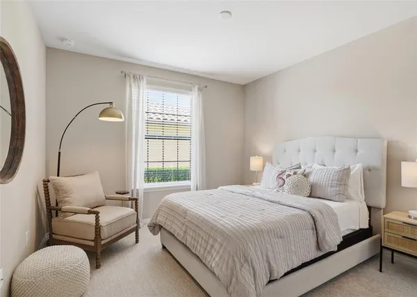 a bedroom with a bed couch and window