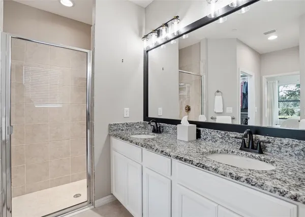a bathroom with double sink and a mirror