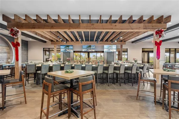 a dining table with chairs and a view of kitchen
