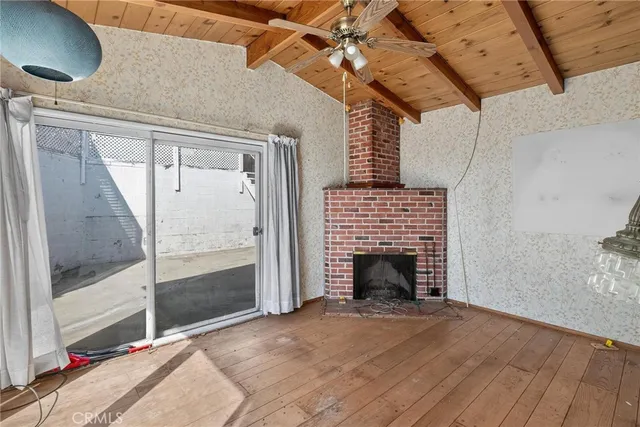 a view of empty room with fireplace and fan