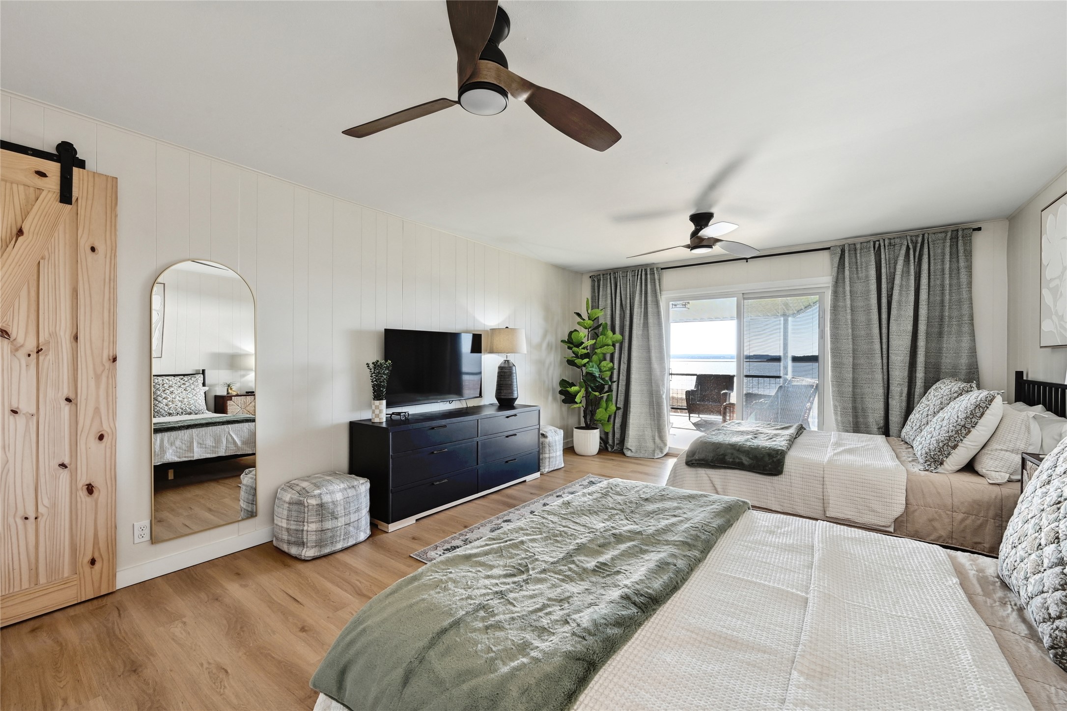 611 Lakeshore Loop Tow, TX 78672 - Photo 17 of 40 Bedroom with access to outside, a barn door, light wood-style flooring, and a ceiling fan