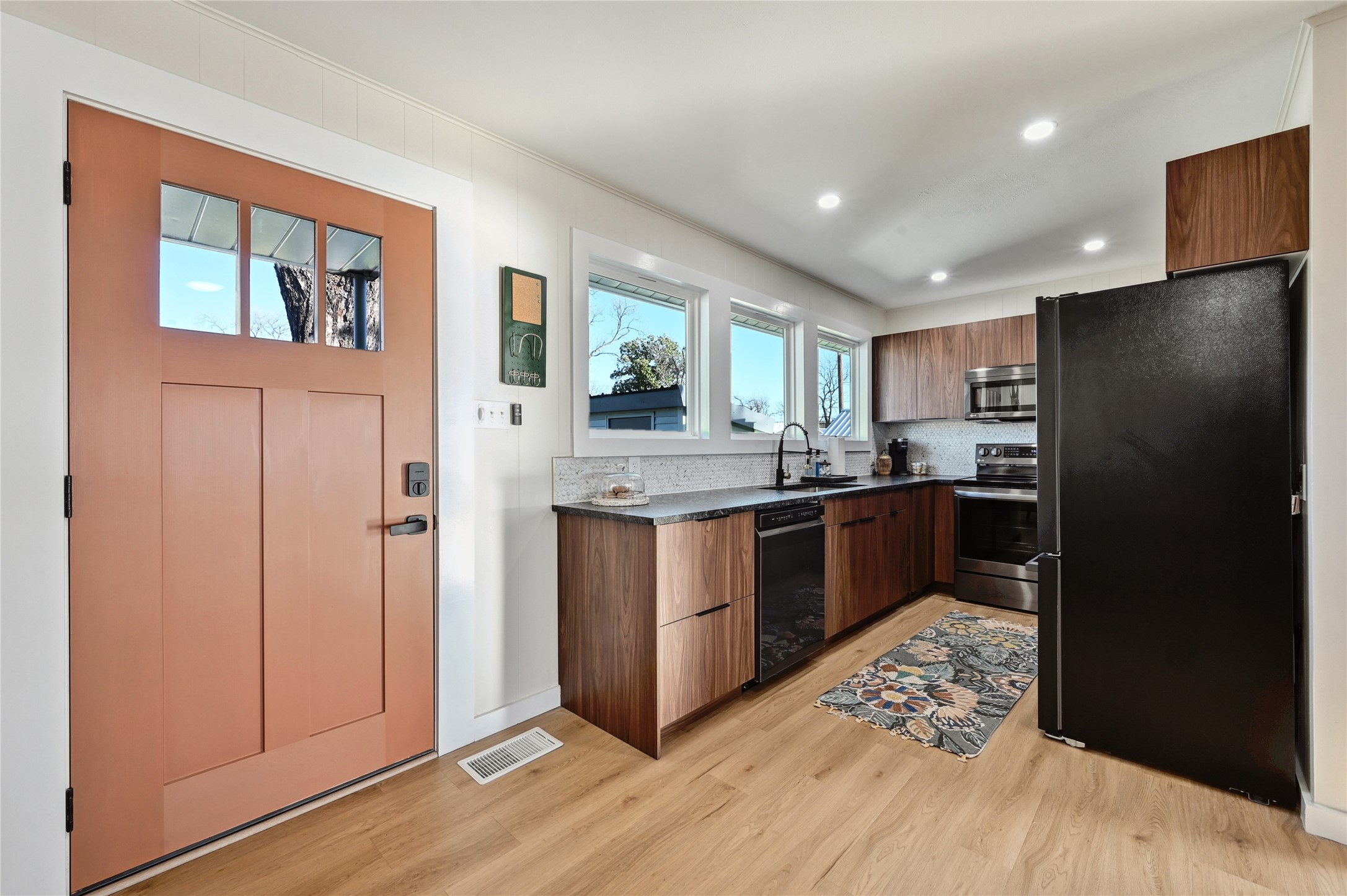 611 Lakeshore Loop Tow, TX 78672 - Photo 2 of 40 Kitchen with black appliances, modern cabinets, light wood-type flooring, wood finish cabinetry, and recessed lighting
