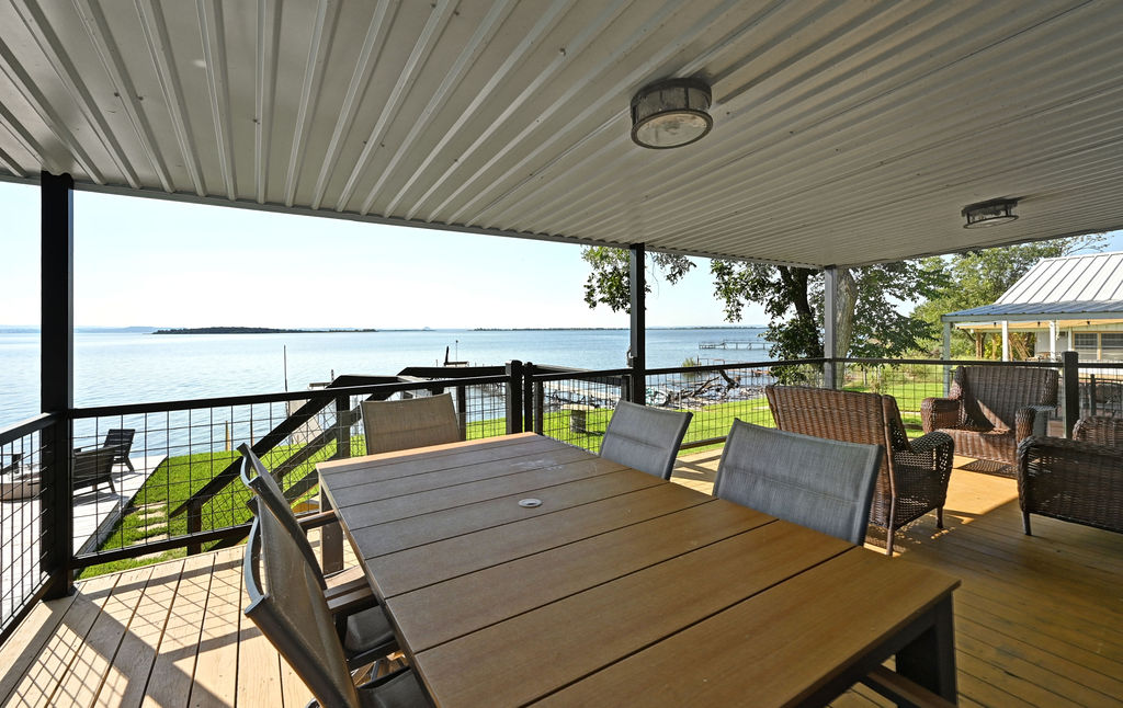 611 Lakeshore Loop Tow, TX 78672 - Photo 23 of 40 Wooden terrace featuring a water view and outdoor dining area