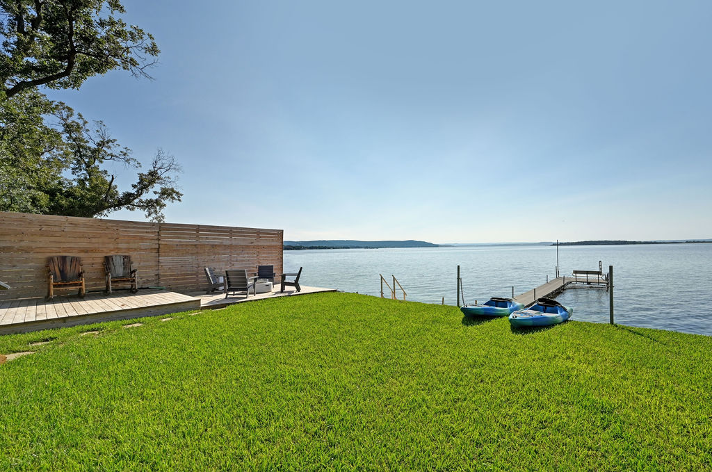 611 Lakeshore Loop Tow, TX 78672 - Photo 25 of 40 View of grassy yard with a boat dock and a deck with water view