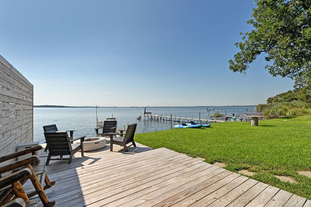 611 Lakeshore Loop Tow, TX 78672 - Photo 30 of 40 Wooden deck featuring a water view, a lawn, a boat dock, and an outdoor fire pit