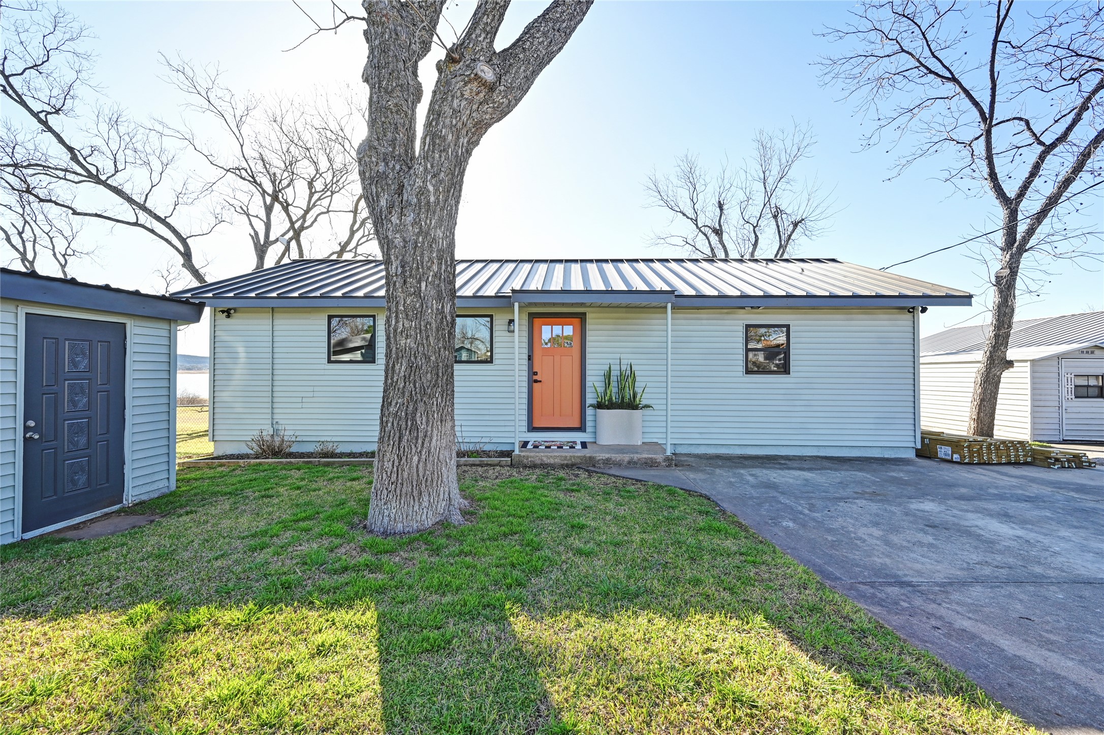 611 Lakeshore Loop Tow, TX 78672 - Photo 40 of 40 Single story home featuring a metal roof, a front yard, and asphalt driveway