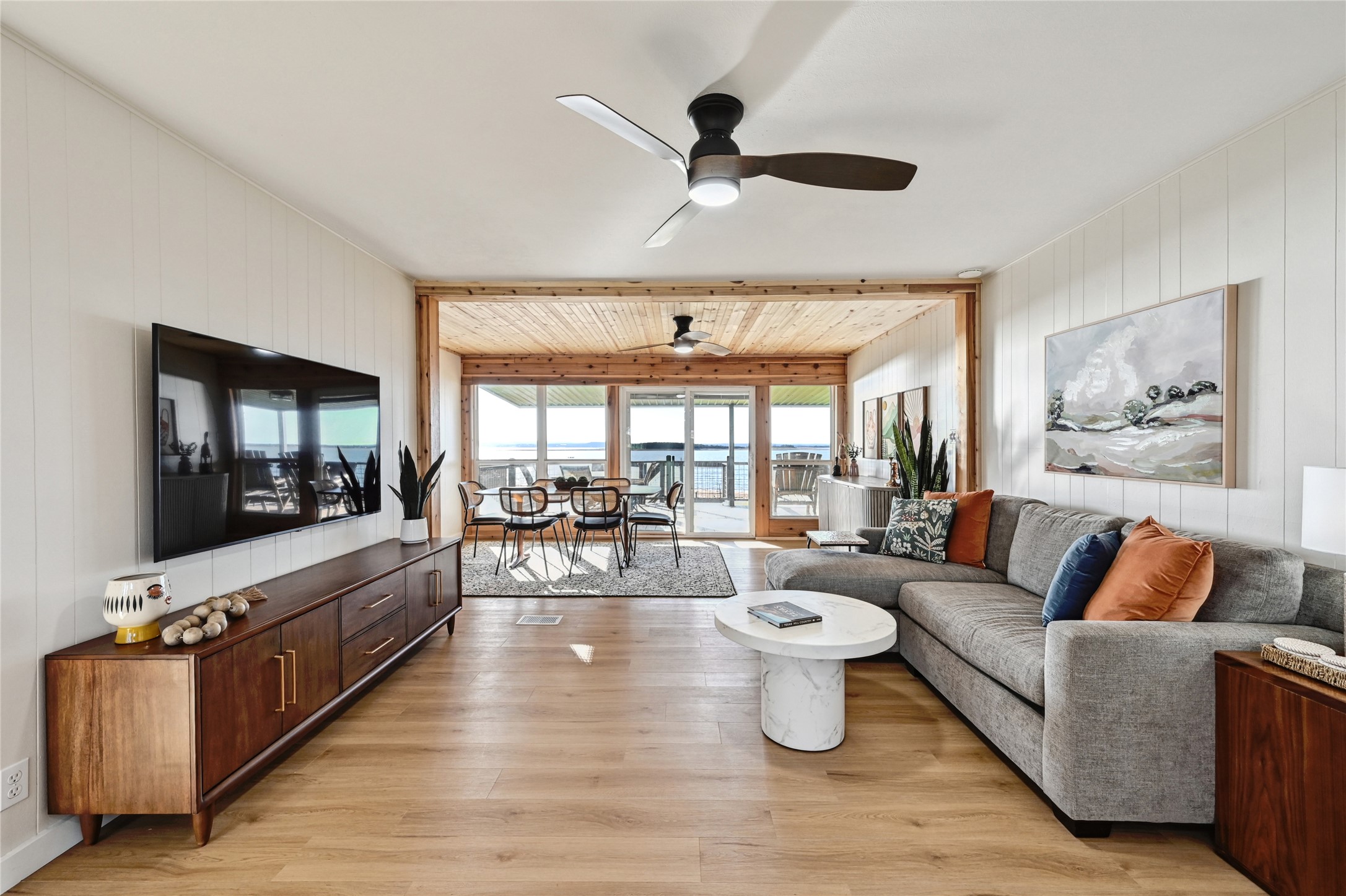 611 Lakeshore Loop Tow, TX 78672 - Photo 8 of 40 Living room featuring a ceiling fan, wooden walls, and light wood-type flooring