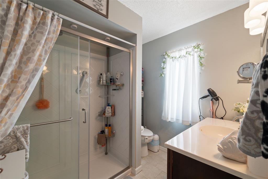 12265 Shafton Road Spring Hill, FL 34608 - Photo 12 of 51 a bathroom with a sink toilet and shower