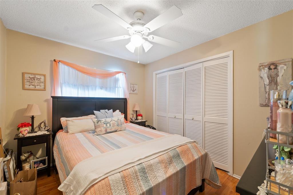 12265 Shafton Road Spring Hill, FL 34608 - Photo 13 of 51 a bedroom with a bed and a chandelier