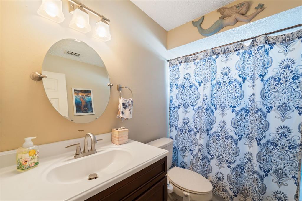 12265 Shafton Road Spring Hill, FL 34608 - Photo 14 of 51 a bathroom with a sink toilet and mirror