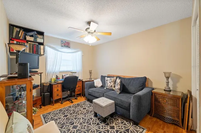 a living room with patio furniture and a floor to ceiling window