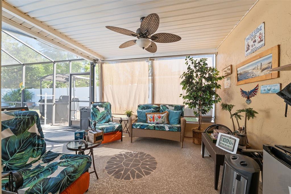 12265 Shafton Road Spring Hill, FL 34608 - Photo 16 of 51 a living room with patio furniture and a floor to ceiling window