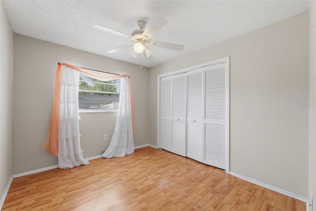 12265 Shafton Road Spring Hill, FL 34608 - Photo 17 of 58 a bedroom with a bed and a window