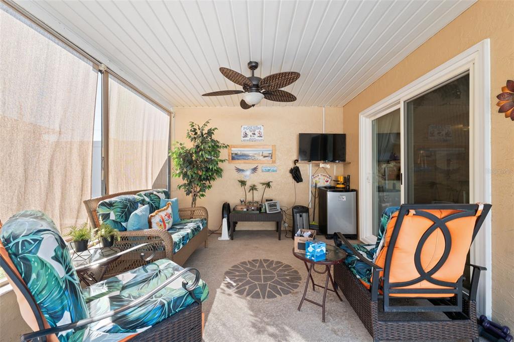12265 Shafton Road Spring Hill, FL 34608 - Photo 17 of 51 a living room with patio furniture and a flat screen tv