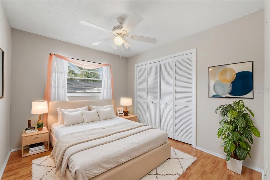 12265 Shafton Road Spring Hill, FL 34608 - Photo 18 of 58 a bedroom with a bed and a chandelier