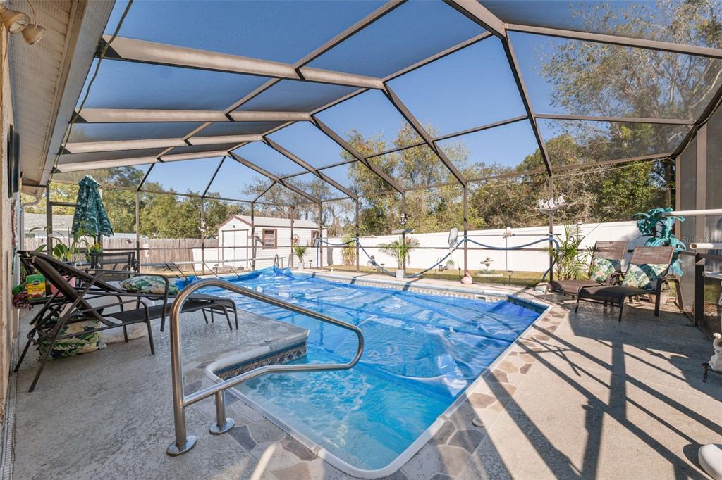 12265 Shafton Road Spring Hill, FL 34608 - Photo 18 of 51 a view of a swimming pool with a patio