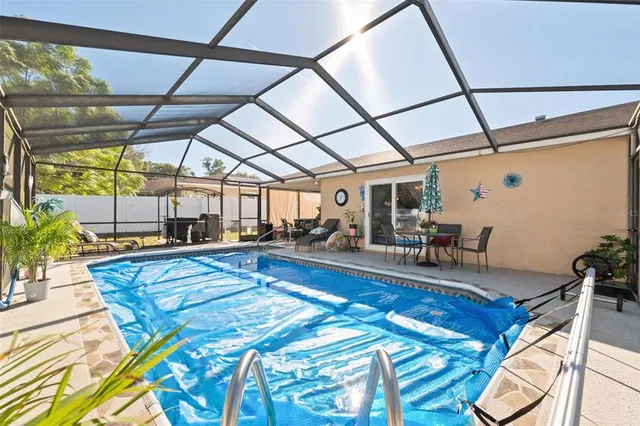 a view of a swimming pool with a yard