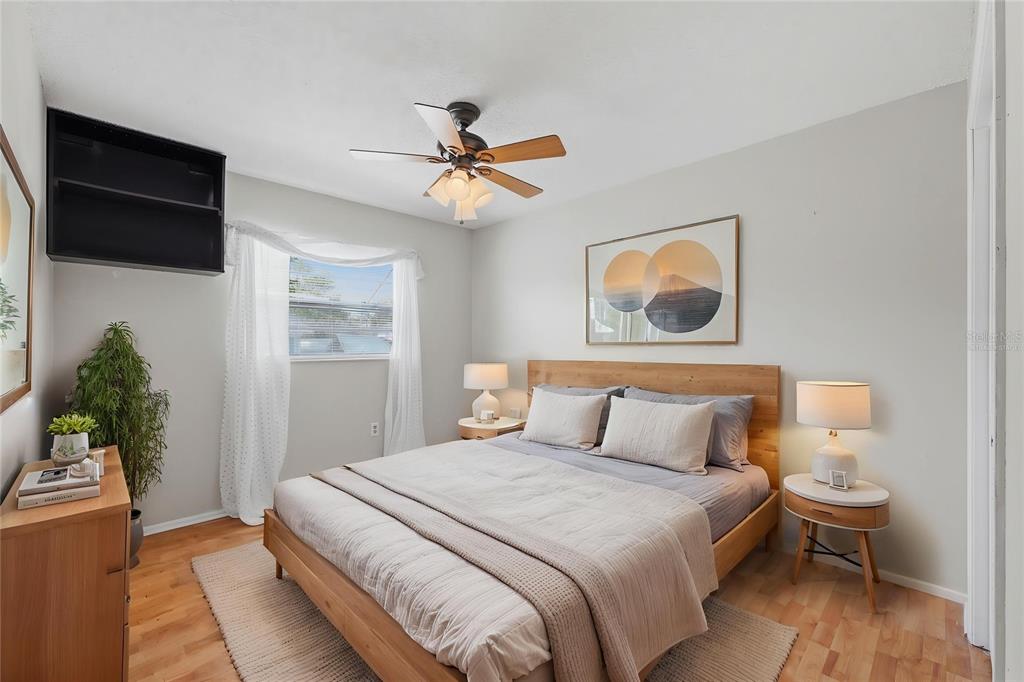 12265 Shafton Road Spring Hill, FL 34608 - Photo 20 of 58 a bedroom with a bed and a chandelier