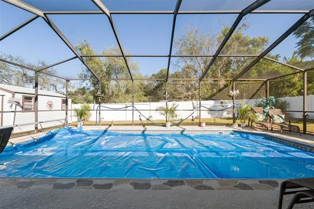a view of a porch with chairs and backyard