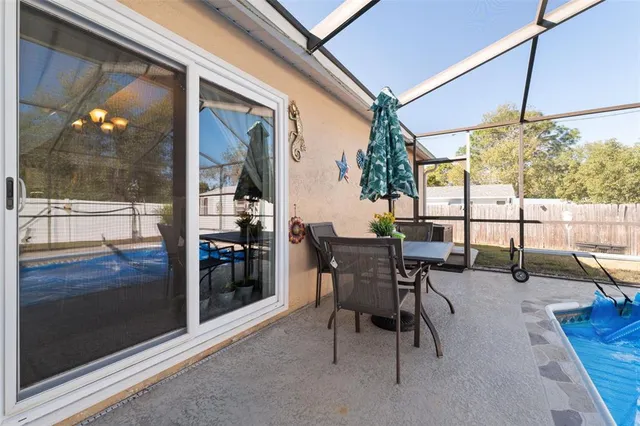 a view of a patio with table and chairs under an umbrella