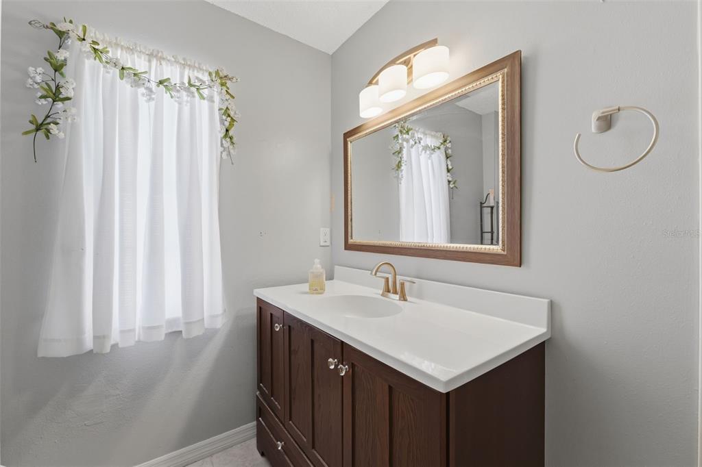 12265 Shafton Road Spring Hill, FL 34608 - Photo 22 of 58 a bathroom with a sink vanity and a mirror