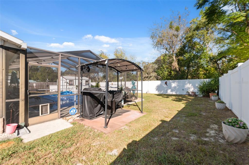 12265 Shafton Road Spring Hill, FL 34608 - Photo 23 of 51 a view of a patio with table and chairs under an umbrella