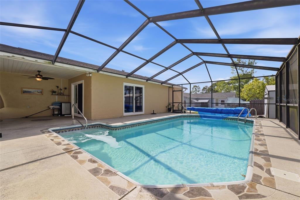 12265 Shafton Road Spring Hill, FL 34608 - Photo 28 of 58 a view of a backyard with a patio and a table