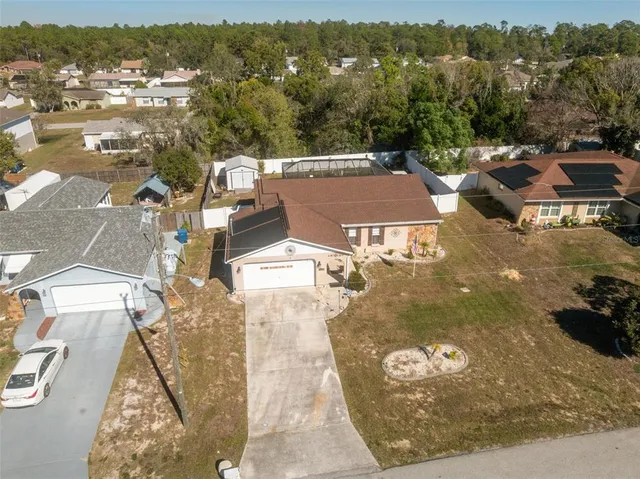 an aerial view of multiple houses with yard