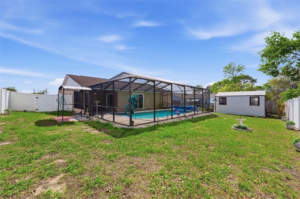 12265 Shafton Road Spring Hill, FL 34608 - Photo 32 of 58 a view of a house with backyard and a tree