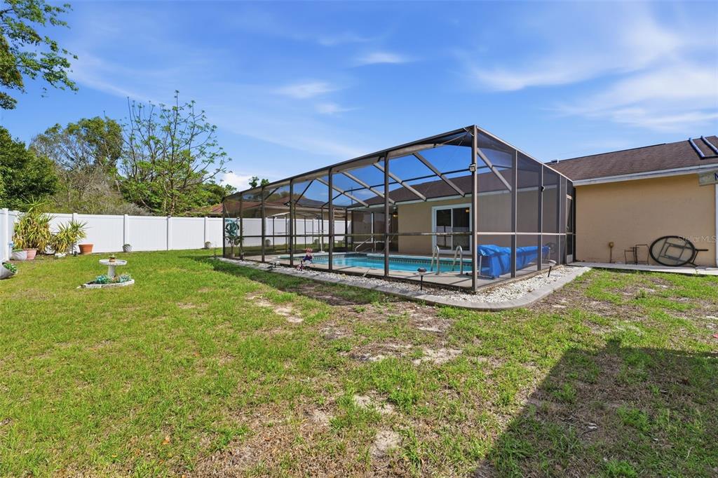 12265 Shafton Road Spring Hill, FL 34608 - Photo 33 of 58 a view of a house with a yard patio and swimming pool