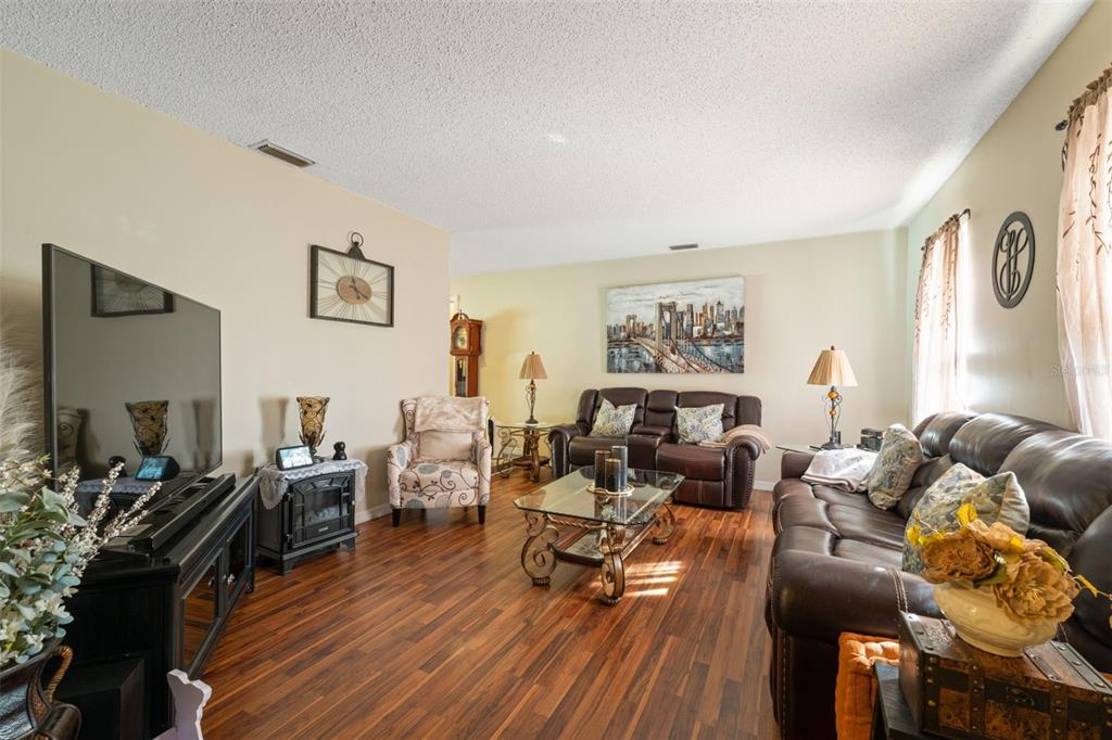 12265 Shafton Road Spring Hill, FL 34608 - Photo 44 of 51 a living room with furniture and wooden floor