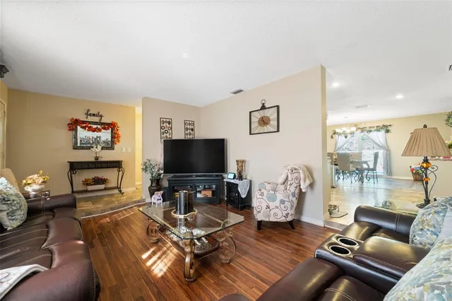 a room with lot of white furniture and window