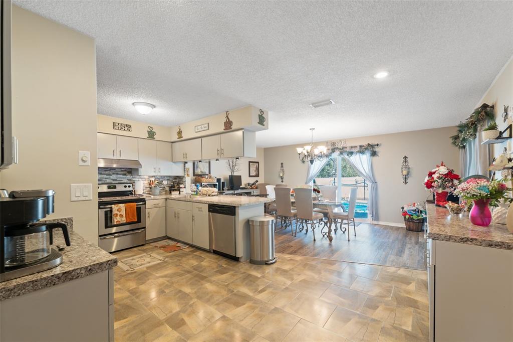 12265 Shafton Road Spring Hill, FL 34608 - Photo 46 of 51 a kitchen with lots of counter top space and dining table