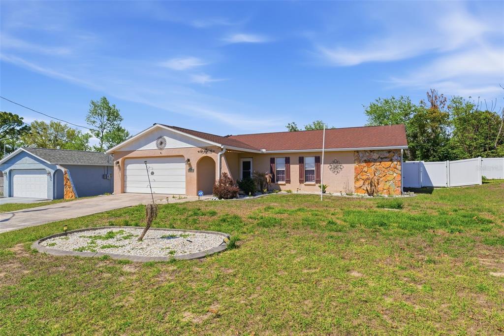 12265 Shafton Road Spring Hill, FL 34608 - Photo 48 of 58 a front view of a house with a yard